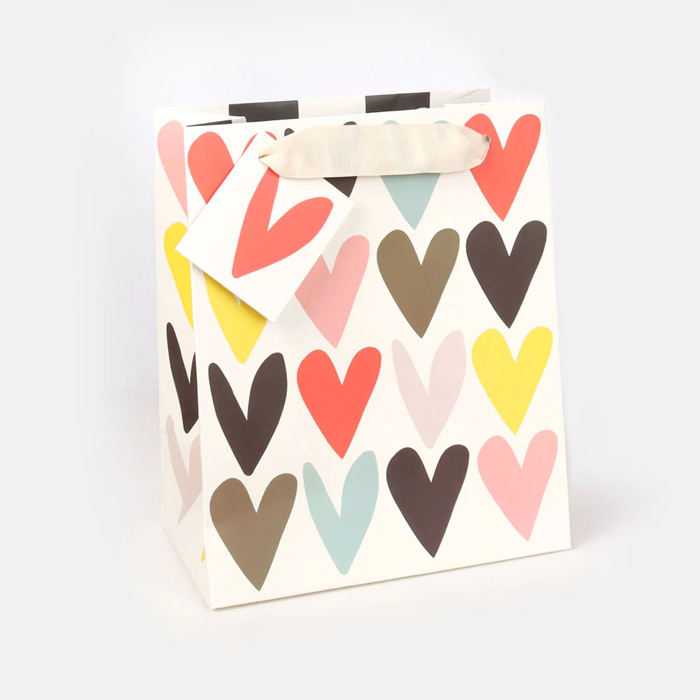 Caroline Gardner Jumbled Hearts medium gift bag with colorful heart pattern for gift wrapping and presentation.