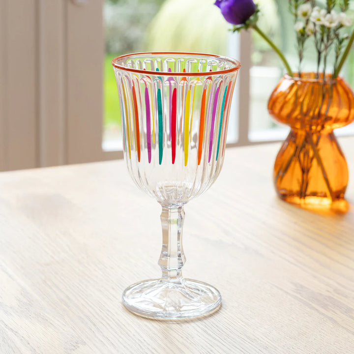 Bright multicolour striped wine glass by Cornucopia Home and Gift, featuring a vibrant, colorful design perfect for wine gatherings.