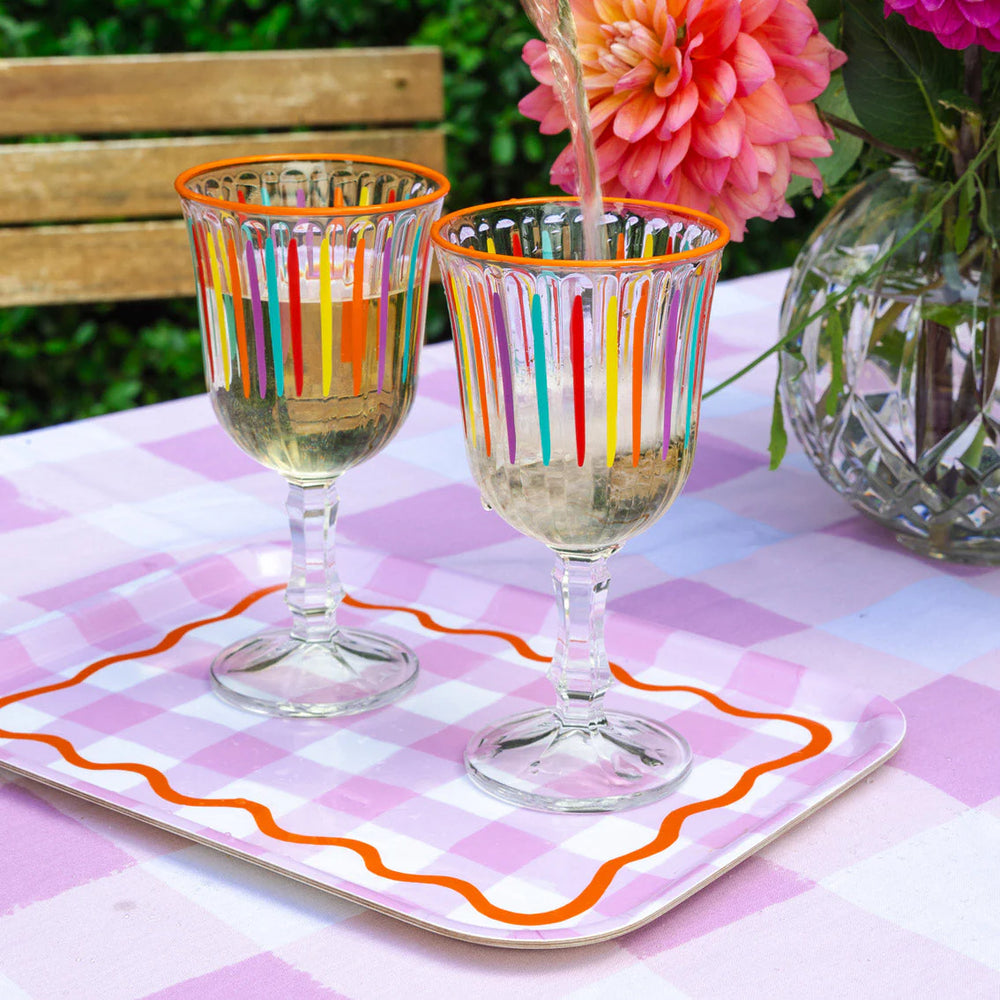 Multicolour striped wine glass from Cornucopia Home and Gift, featuring vibrant, multicoloured stripes on a clear glass wine drinkware.
