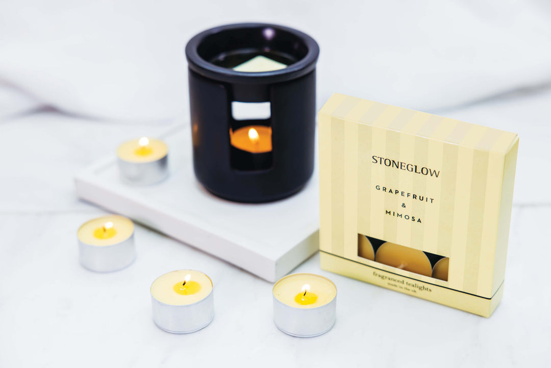 Set of Stoneglow grapefruit and mimosa scented tealights in clear glass holders, ideal for home décor and ambient lighting.
