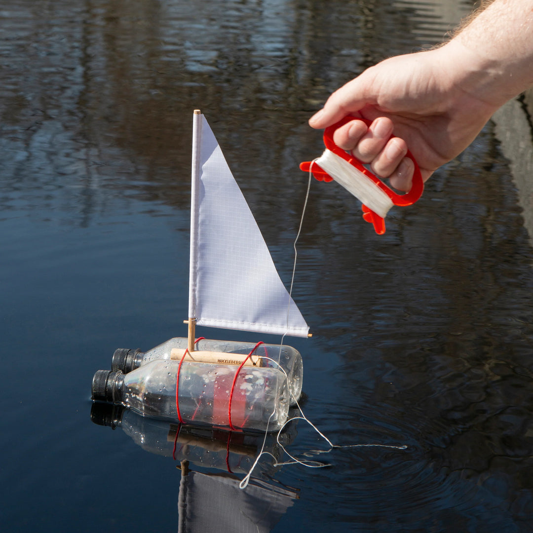 Kikkerland Huckleberry Sailboat decorative item with colorful sails, crafted by Cornucopia Home and Gift, displayed on a white background.