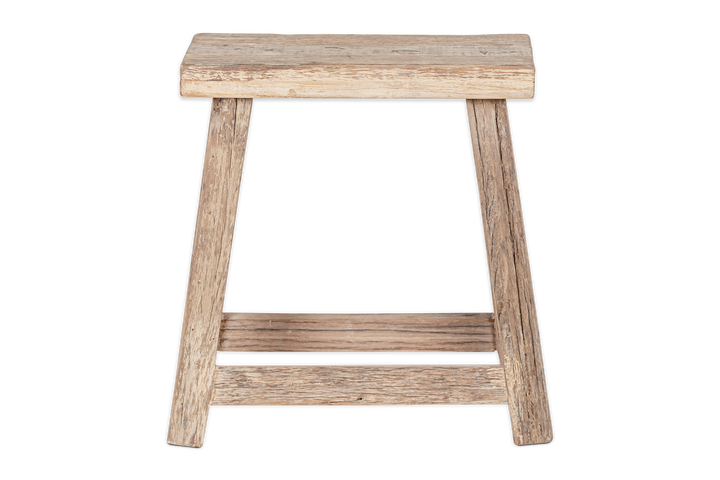 Nkuku Ibo side table by Cornucopia Home and Gift, made from reclaimed wood, showcasing a natural low stool design with a smooth finish.