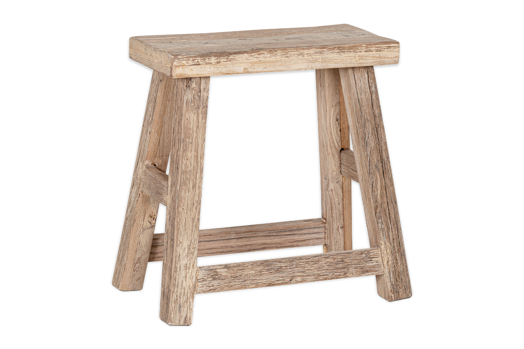 Nkuku Ibo side table made of reclaimed natural wood, featuring a low, round design with a smooth surface and sturdy legs.
