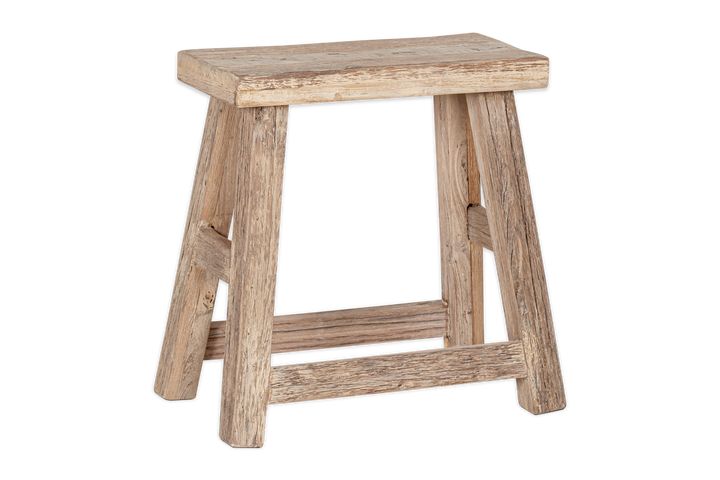 Nkuku Ibo side table made of reclaimed natural wood, featuring a low, round design with a smooth surface and sturdy legs.