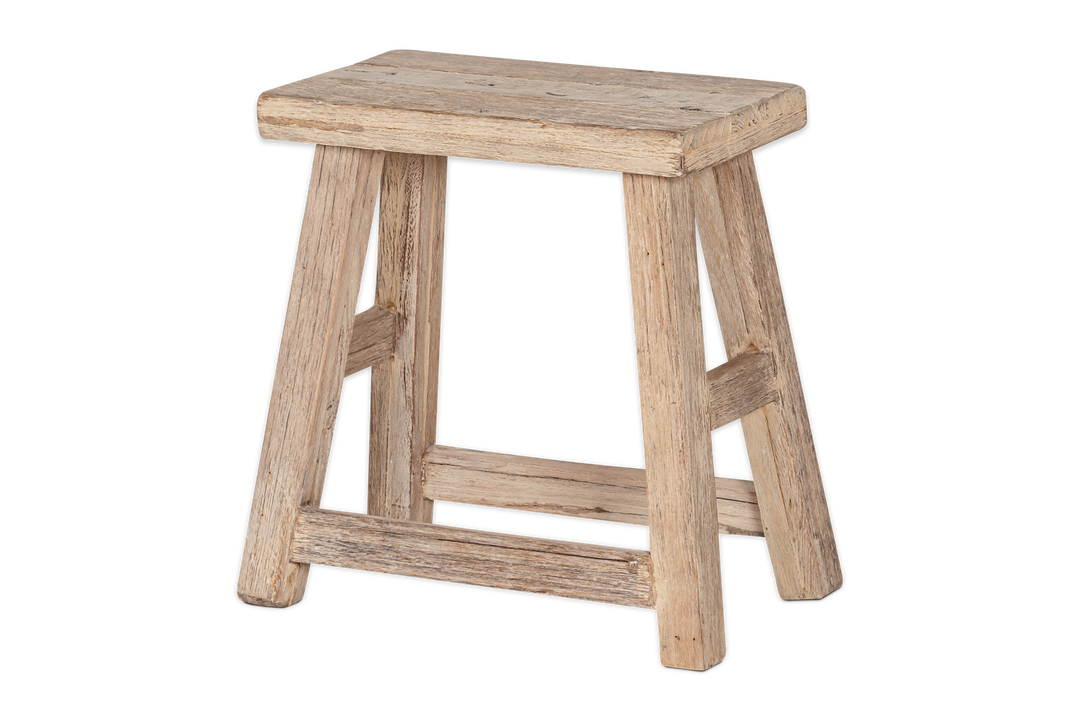 Nkuku Ibo side table by Cornucopia Home and Gift, made of reclaimed wood with a natural finish, featuring a low, round design.