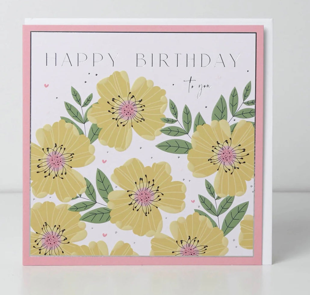 Belly button with a "Happy Birthday To You" card featuring yellow roses, from Cornucopia Home and Gift.