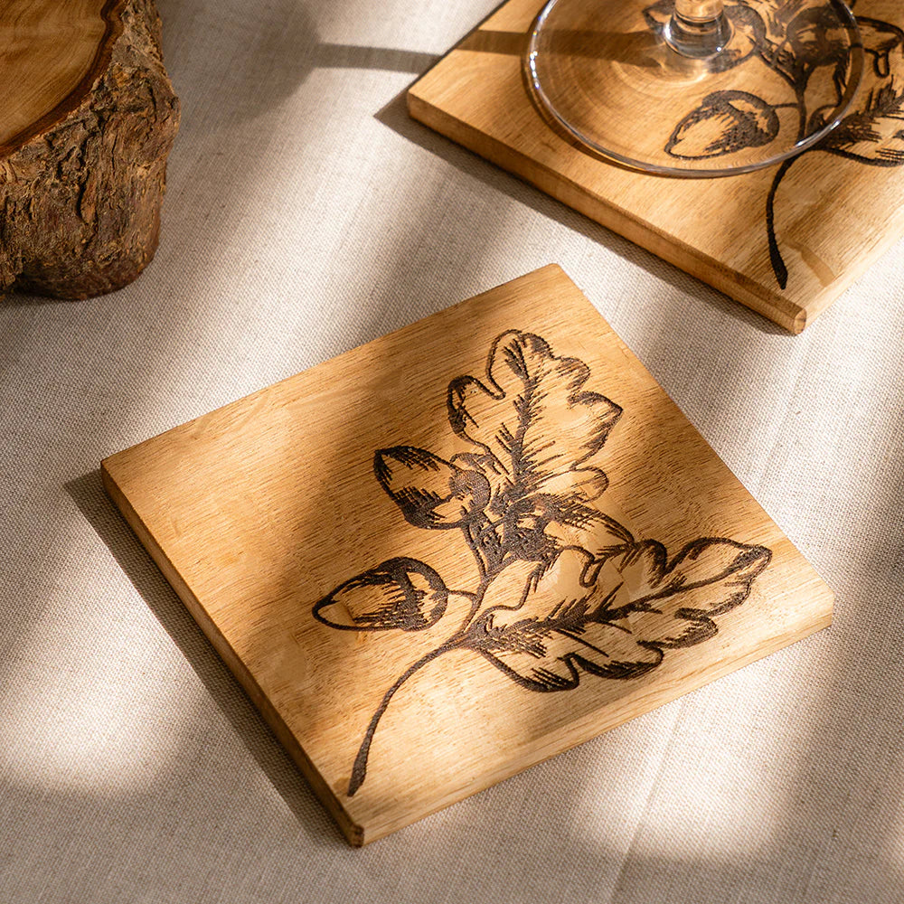 Selbrae House single oak coaster featuring autumn acorns design, crafted by Cornucopia Home and Gift, with a natural wood finish.