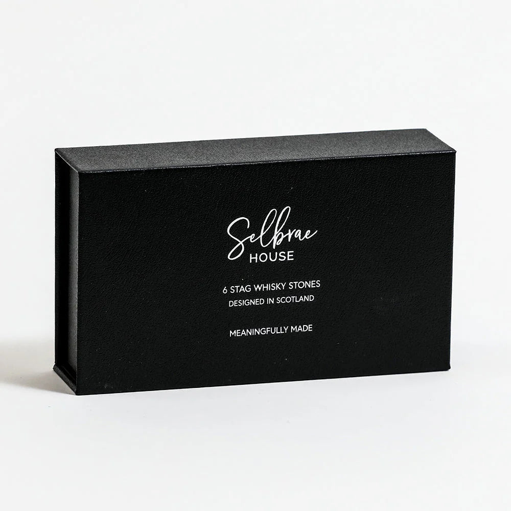 Set of six Selbrae House Stag Whisky Stones by Cornucopia Home and Gift, shown in a clear container with textured finish