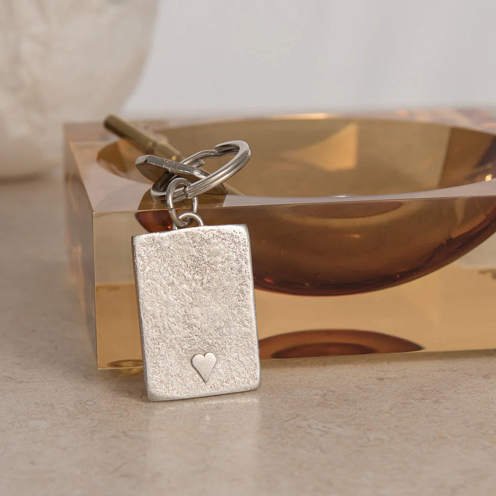 Handmade pewter small raised heart keyring by Lancaster and Gibbings for Cornucopia Home and Gift, featuring a detailed heart design.