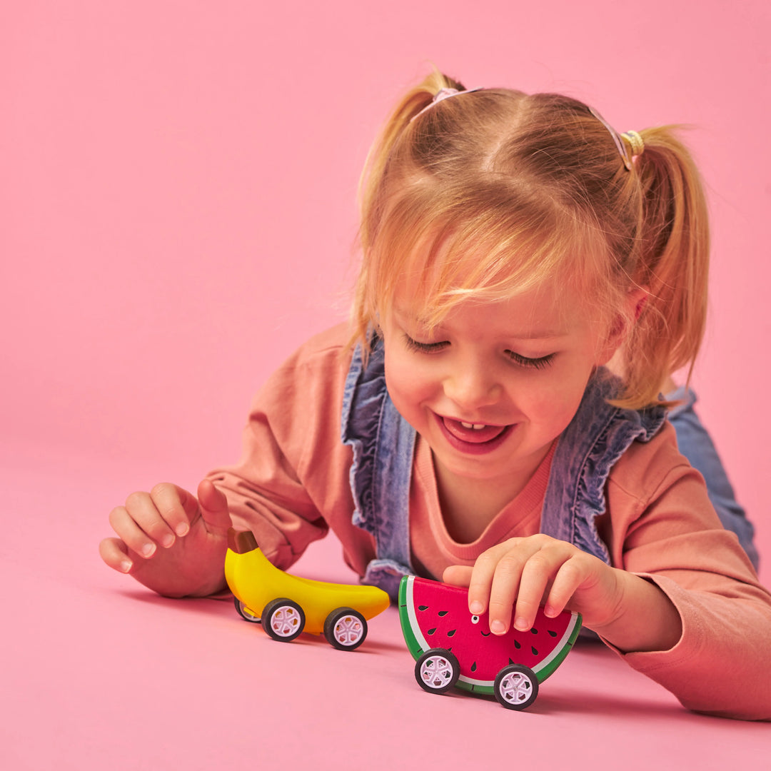 Colorful Fruit-Fun Pull Back Cars by Kikkerland, featuring vibrant fruit-themed designs for kids, on a plain background.