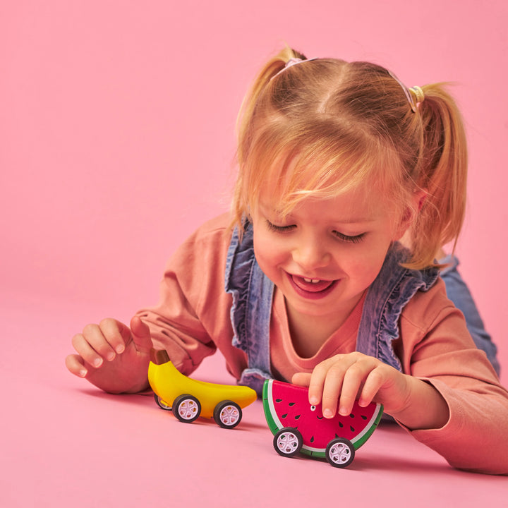 Colorful Fruit-Fun Pull Back Cars by Kikkerland, featuring vibrant fruit-themed designs for kids, on a plain background.