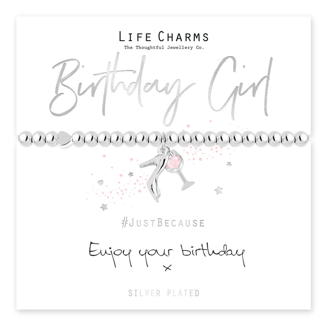 Silver birthday girl charm bracelet from Cornucopia Home and Gift with colorful life charms and a delicate chain.