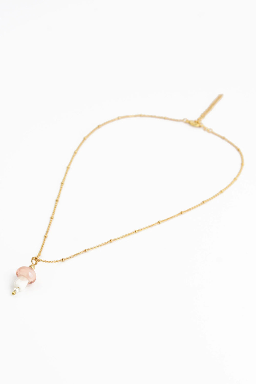 Light pink glass mushroom pendant necklace from My Doris, featuring a delicate mushroom design on a silver chain.