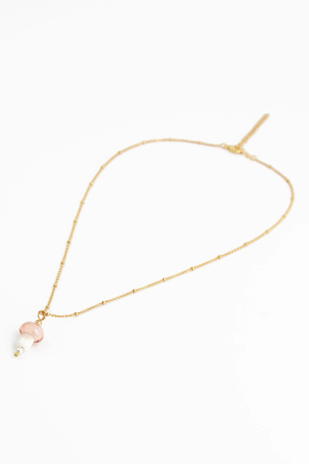 Light pink glass mushroom pendant necklace from My Doris, featuring a delicate mushroom design on a silver chain.
