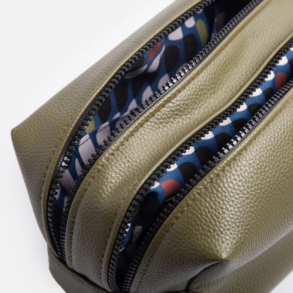 Large dark green Caroline Gardner travel washbag with a spacious design, perfect for organizing toiletries on the go.