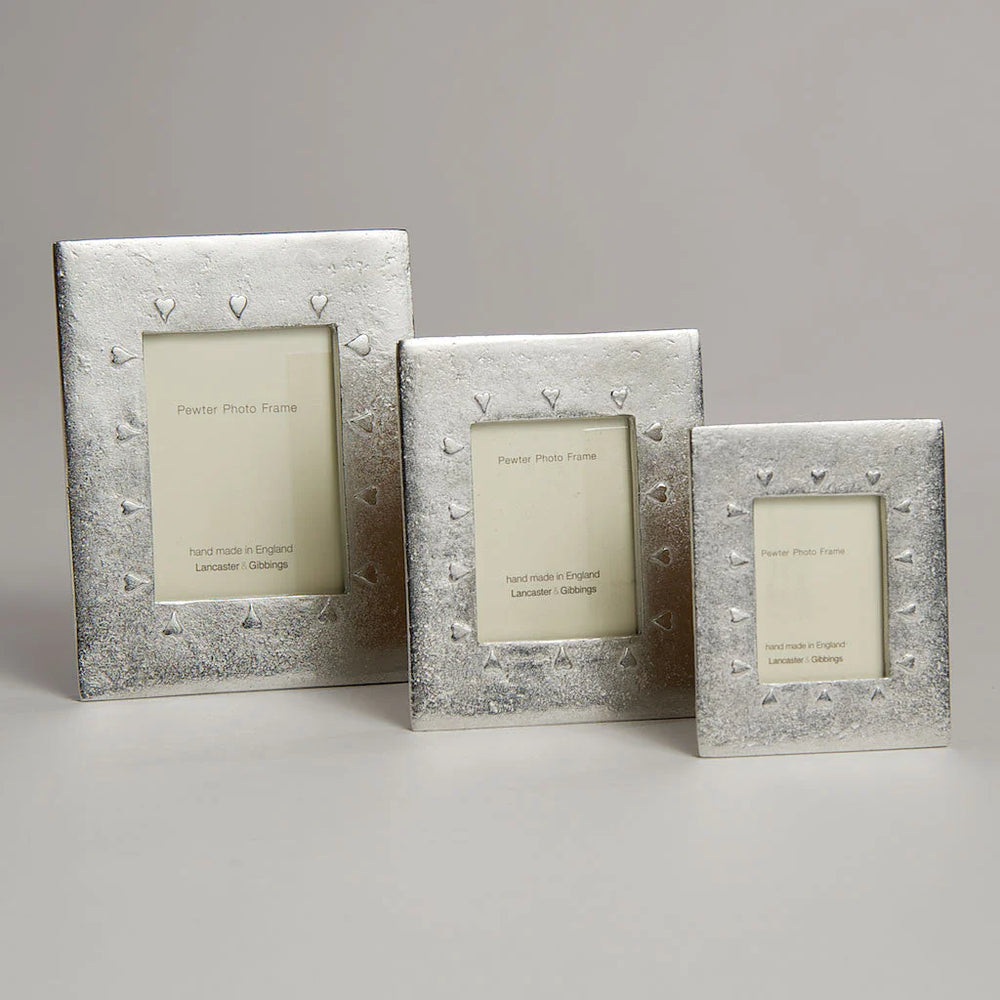 Handmade Lancaster and Gibbings pewter photo frame with mini hearts design, suitable for displaying small photographs.