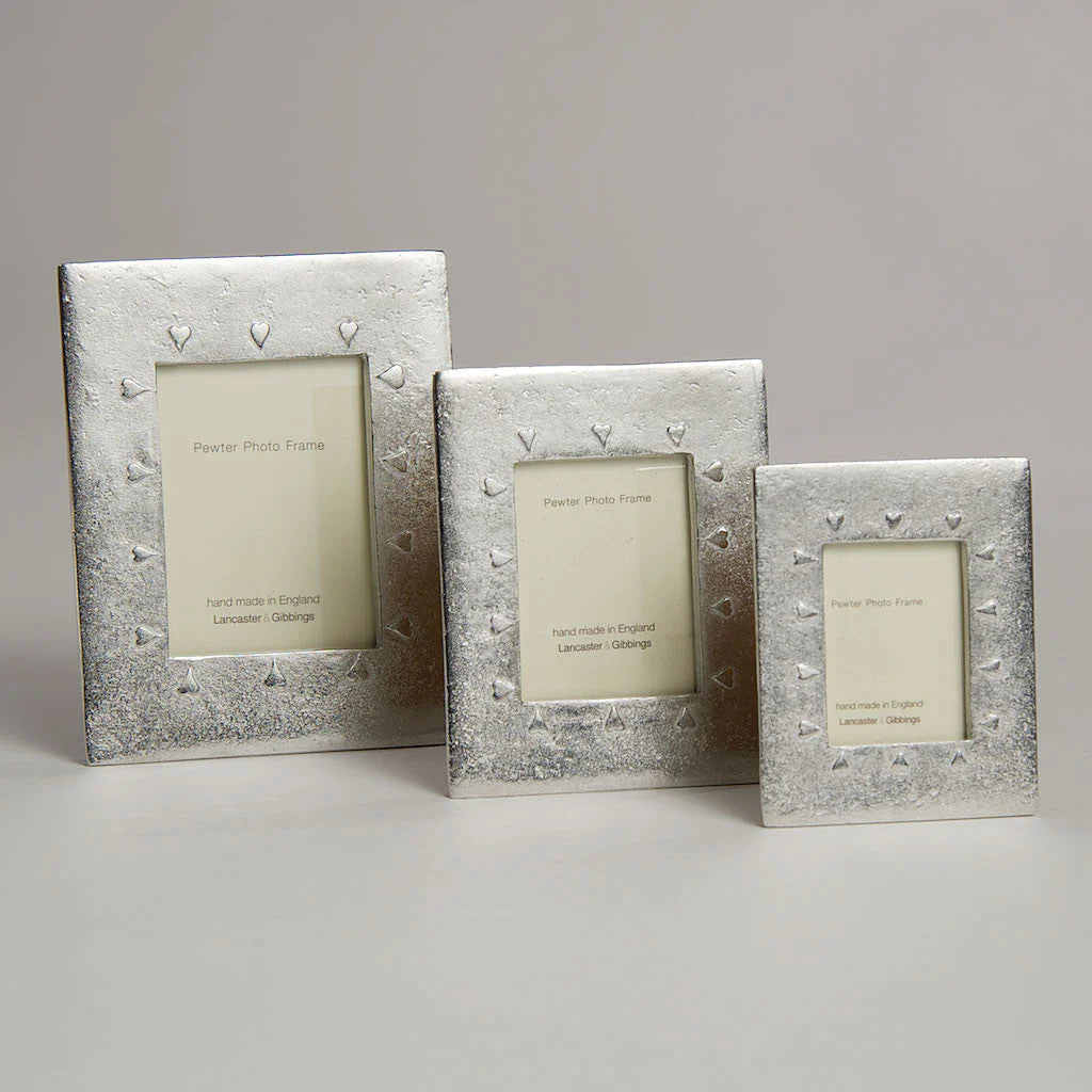 Handmade Lancaster and Gibbings pewter photo frame with mini hearts design, suitable for displaying small photographs.