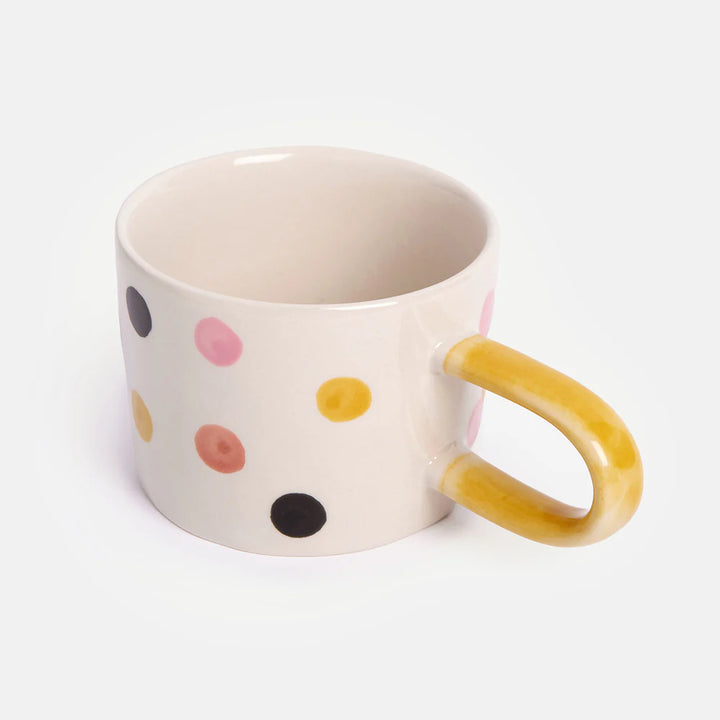Side view of Caroline Gardner Multi Dotty Mug, a stylish ceramic gift with colorful polka dot design by Cornucopia Home and Gift.
