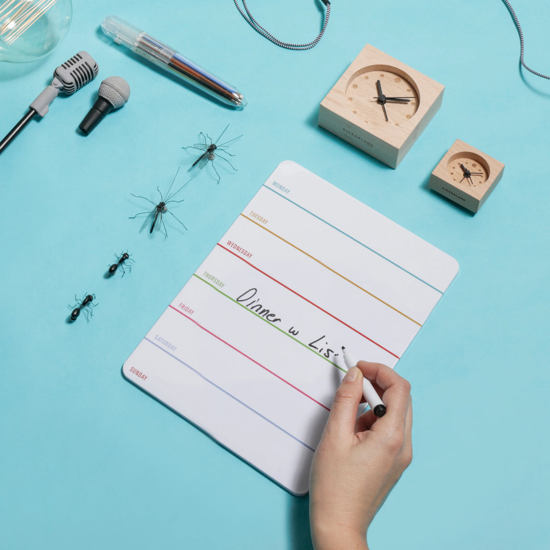Kikkerland Daily Dry Erase Board with sleek white surface and black frame, ideal for notes and planning.