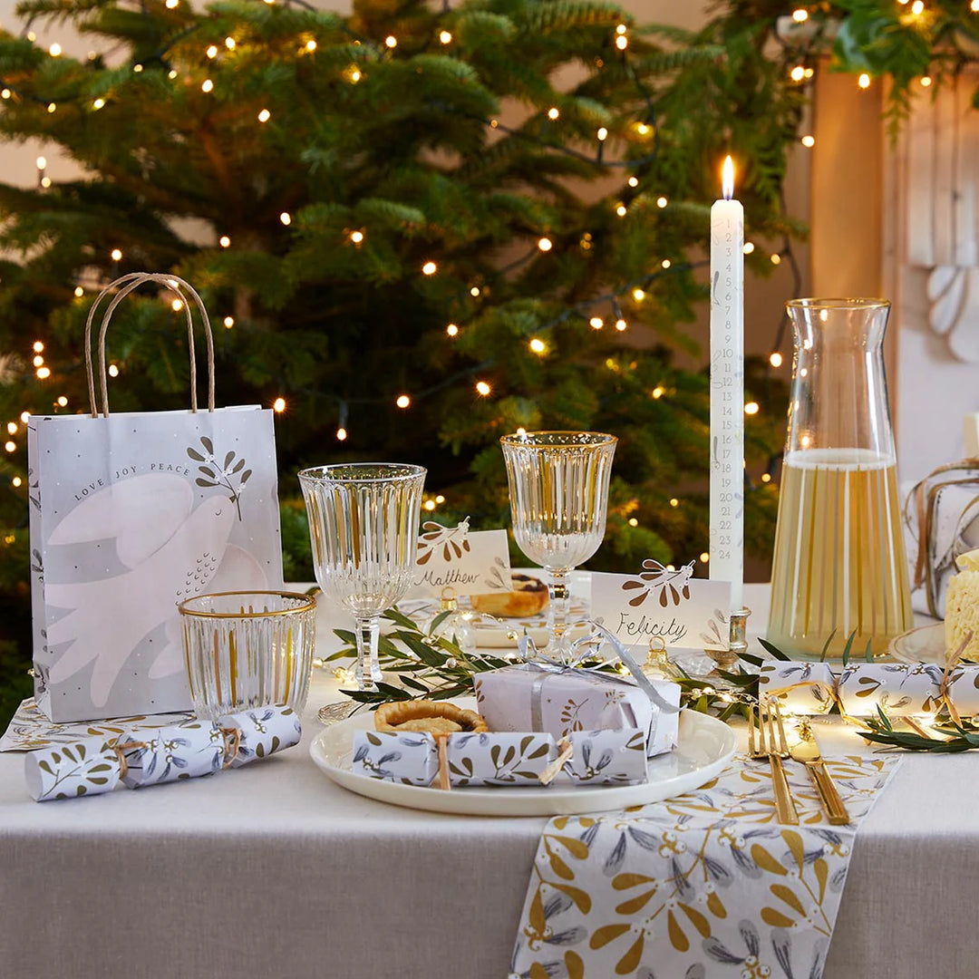 White and gold wine glass from Talking Tables Christmas collection by Cornucopia Home and Gift, with a festive mistletoe design.