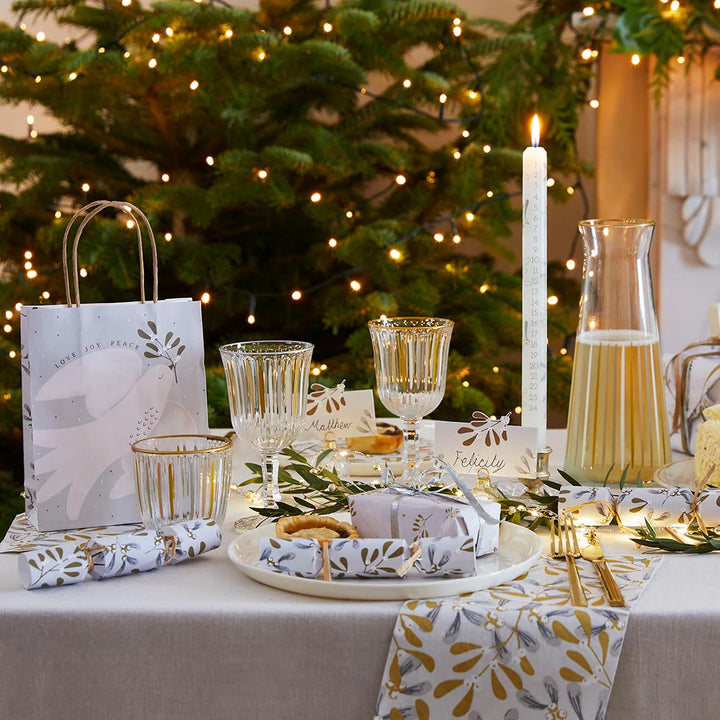 White and gold wine glass from Talking Tables Christmas collection by Cornucopia Home and Gift, with a festive mistletoe design.