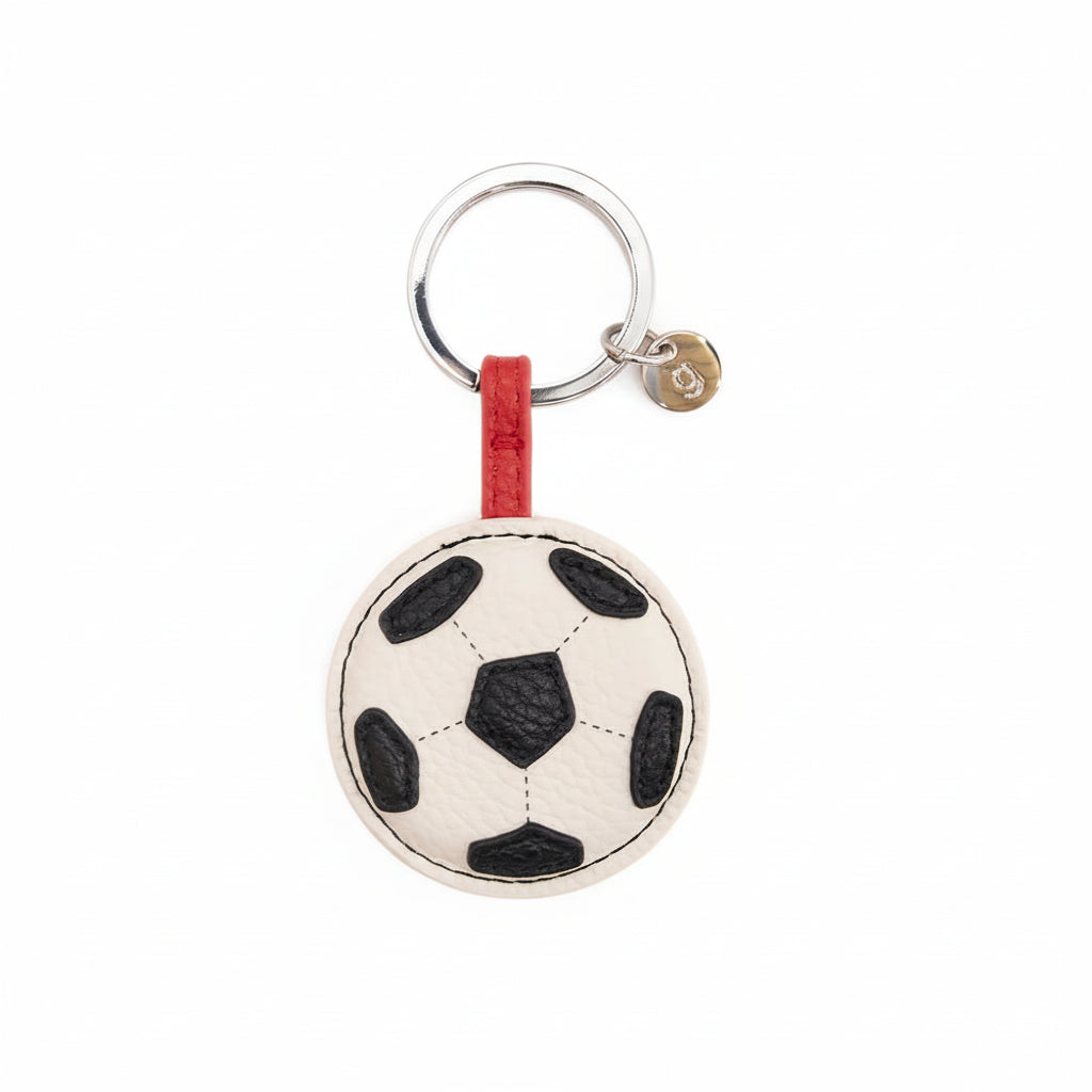 Soccer ball keychain with red strap on a white background