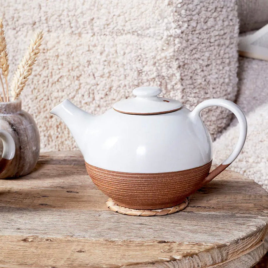 White and terracotta Mali ribbed teapot by Cornucopia Home and Gift, featuring a textured ceramic design and a curved handle.