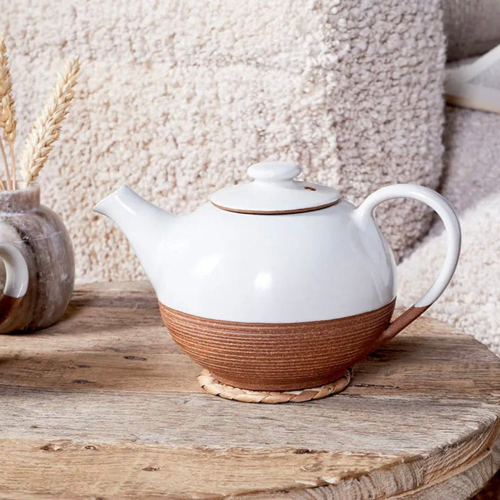 White and terracotta Mali ribbed teapot by Cornucopia Home and Gift, featuring a textured ceramic design and a curved handle.