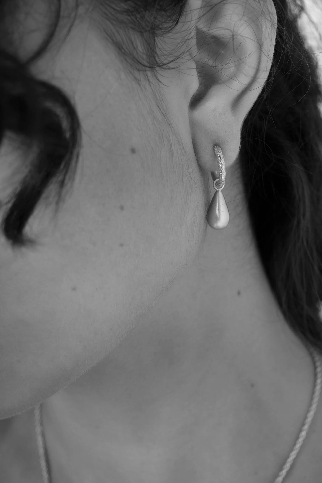 Silver pebble earrings by Tutti &amp; Co, featuring smooth, rounded design, displayed on a neutral background.