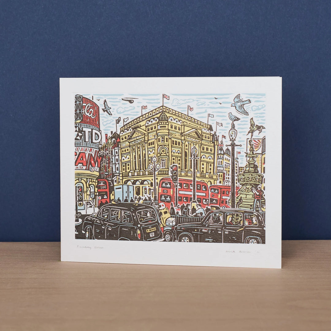 Colorful Piccadilly Circus art card by Cornucopia Home and Gift, featuring vibrant street scene artwork by Mick Armson.