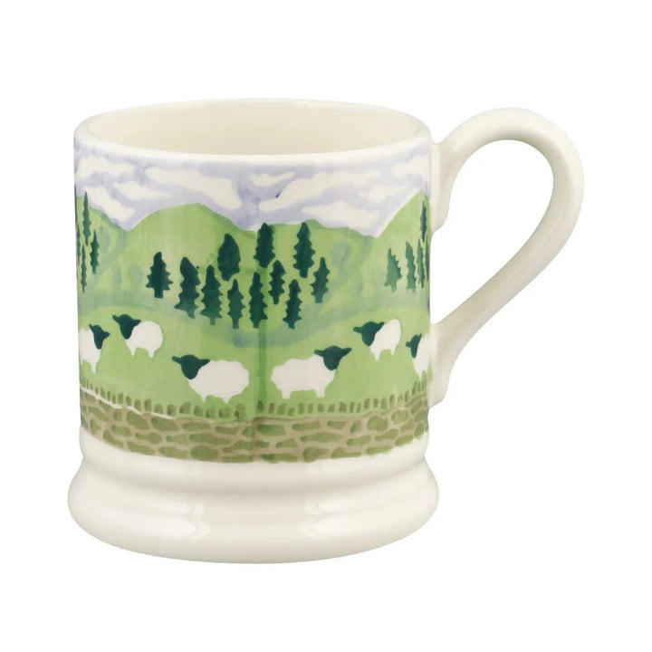 Mug with a scenic design of trees and sheep on a white background