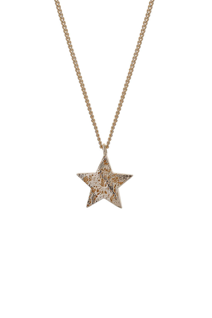 Gold Cosma Necklace by Tutti &amp; Co featuring a delicate chain and pendant, displayed on a neutral background.