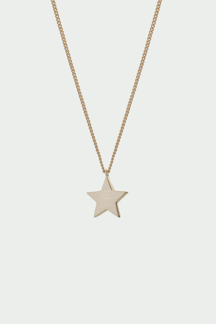 Gold Cosma Necklace by Tutti &amp; Co, featuring a delicate chain and elegant pendant, displayed on a neutral background.