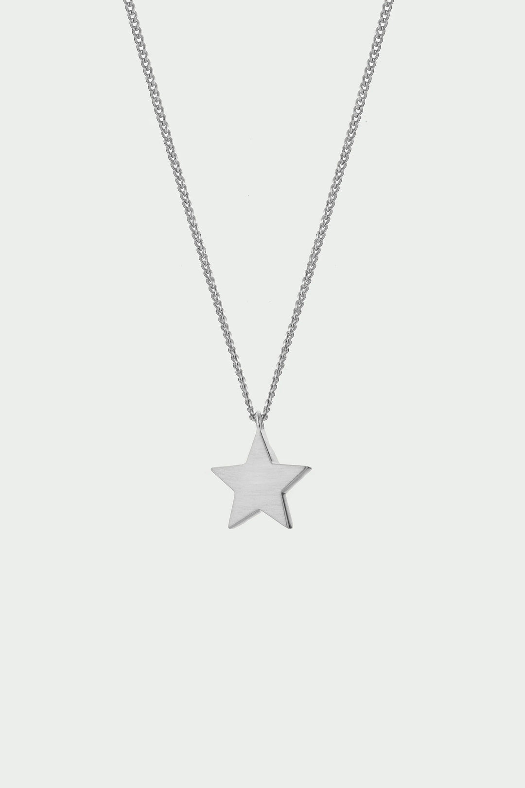 Silver Cosma Necklace by Tutti &amp; Co featuring a delicate chain and minimalist pendant, displayed on a neutral background.