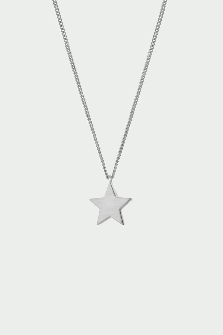 Silver Cosma Necklace by Tutti &amp; Co featuring a delicate chain and minimalist pendant, displayed on a neutral background.
