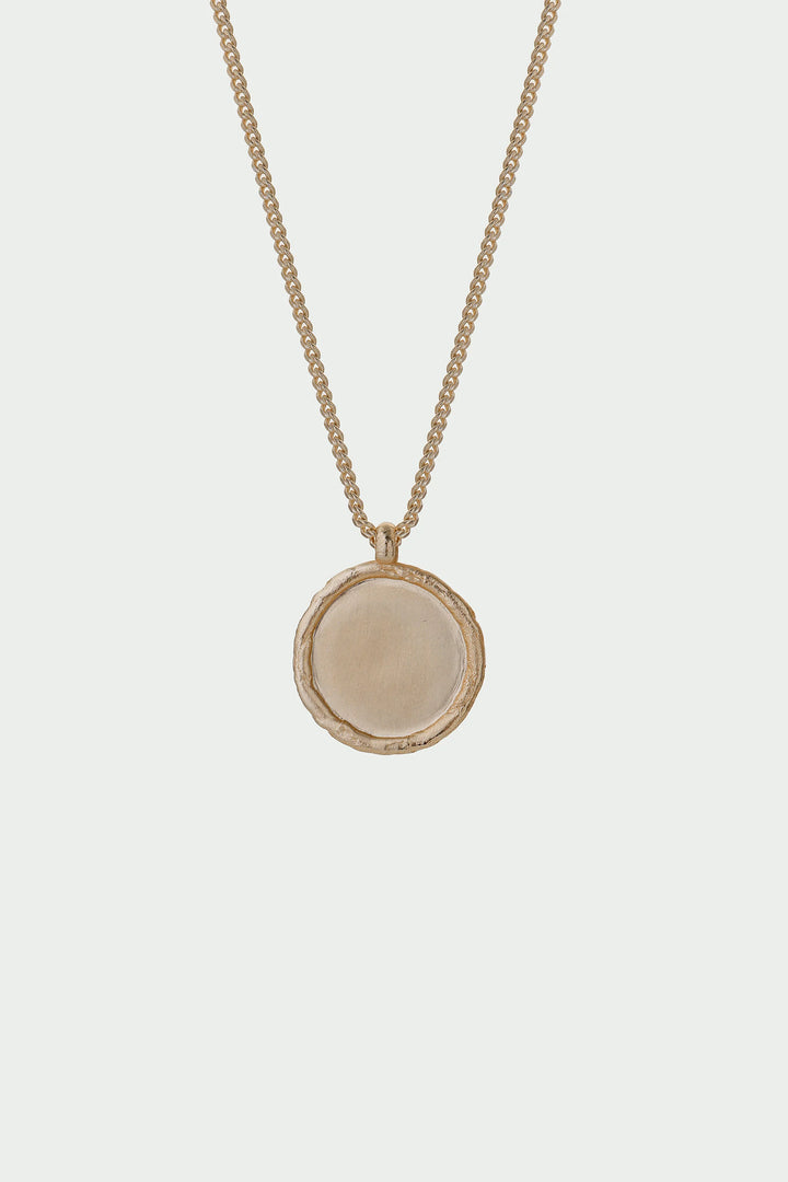 Gold Arc Necklace by Tutti &amp; Co featuring a sleek, curved design, displayed on a neutral background.