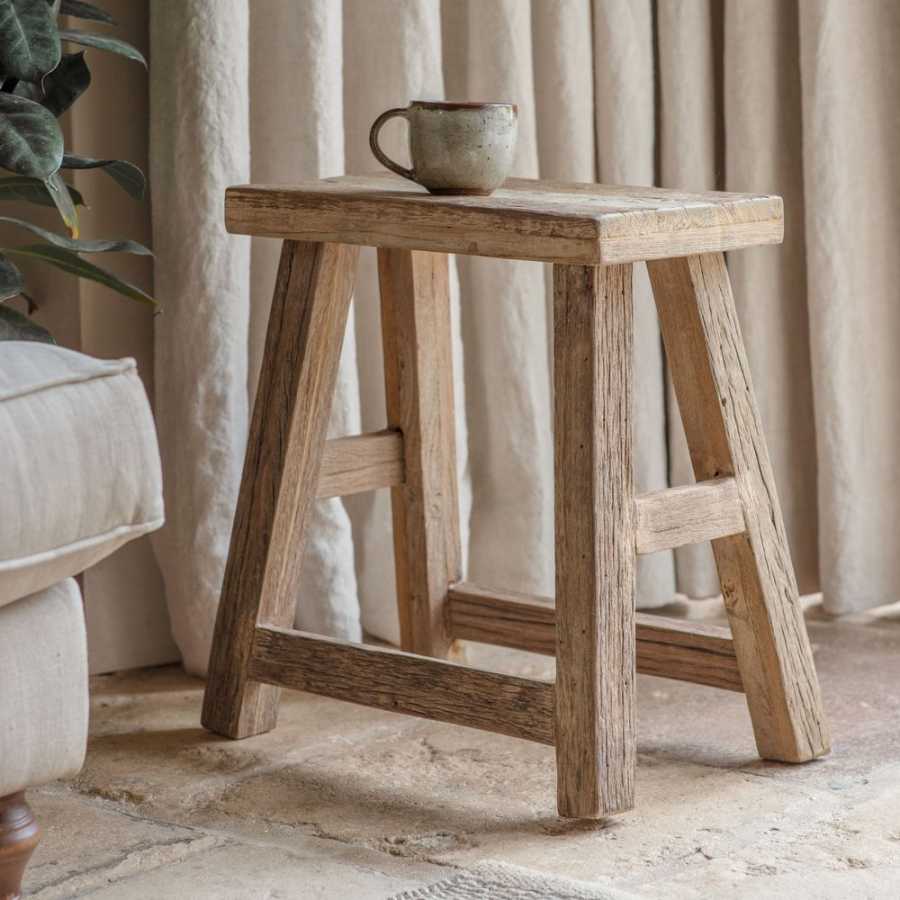 Nkuku Ibo Side Table in natural wood finish, showcasing a stylish and functional piece with a smooth surface and modern design.