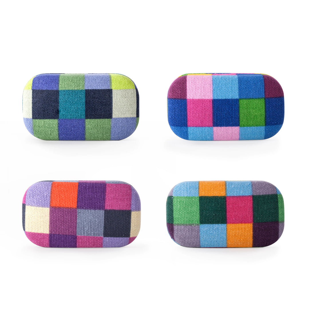 Assorted fabric travel cases by Kikkerland, featuring colorful patterns and compact design for easy packing and organization.