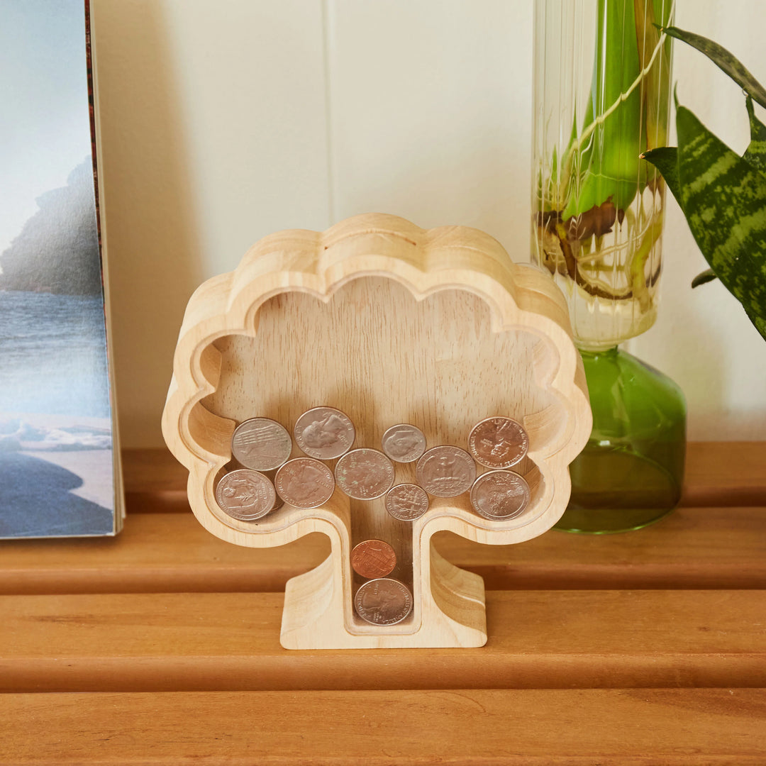 Kikkerland Money Tree Bank from Cornucopia Home and Gift featuring a decorative money tree with a coin slot at the top.