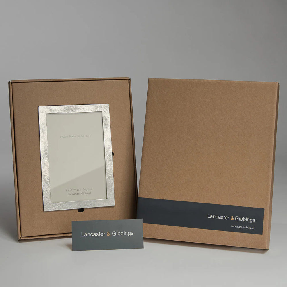 Handmade sandstone and pewter photo frame by Lancaster and Gibbings, packaged in protective wrapping, from Cornucopia Home and Gift.