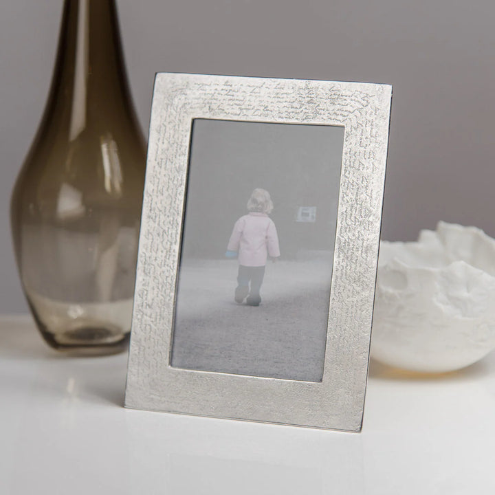 Handmade Lancaster and Gibbings pewter photo frame by Cornucopia Worcester, featuring intricate handwriting details and a polished finish.