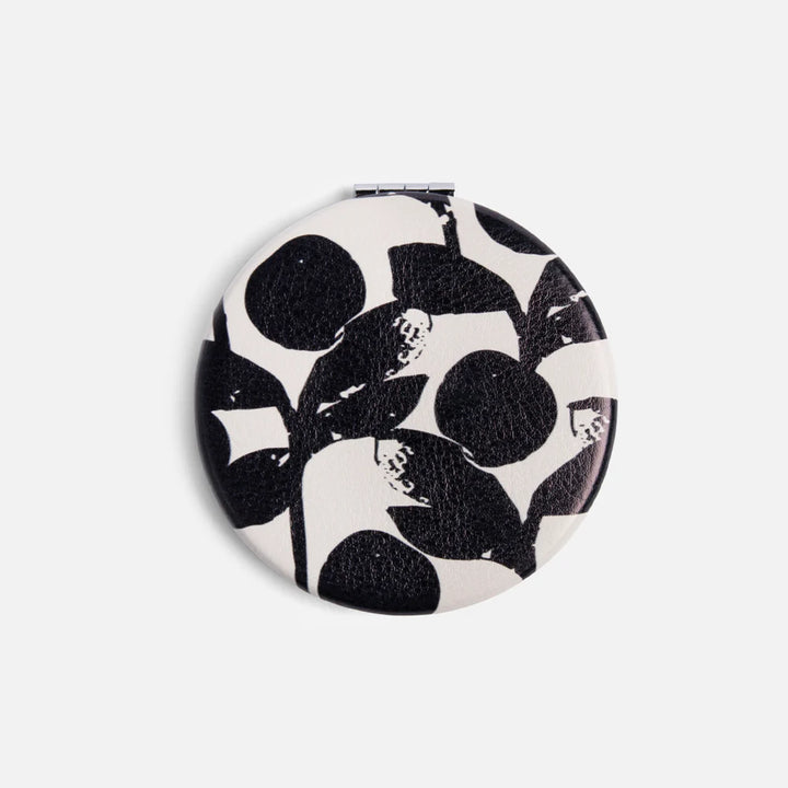 Caroline Gardner Mono Bloom round pocket mirror with floral design and compact size for easy carrying and personal use.