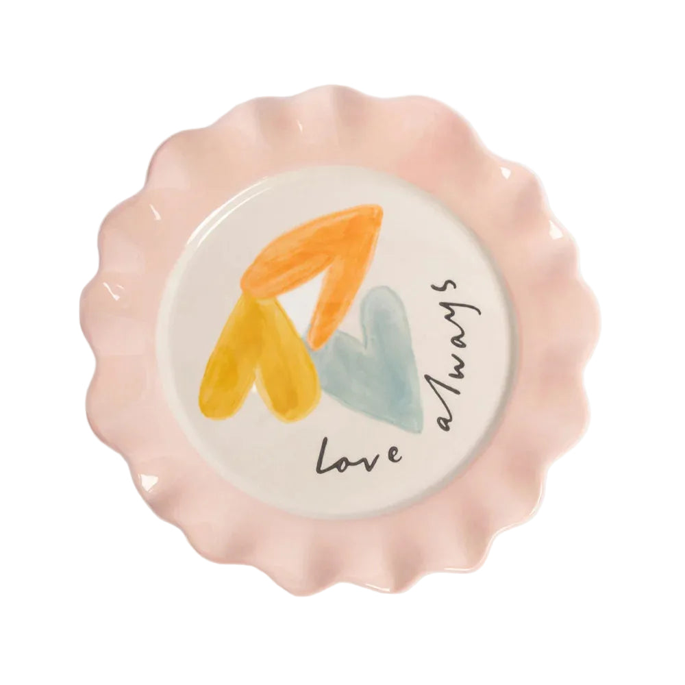 Decorative plate with wavy edge, colorful hearts, and 'love always' text on a light background