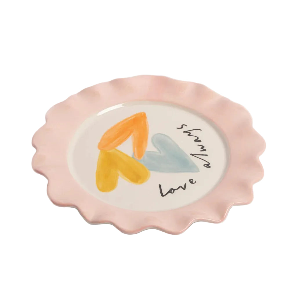 Decorative plate with colorful heart design and 'love always' text on a light background