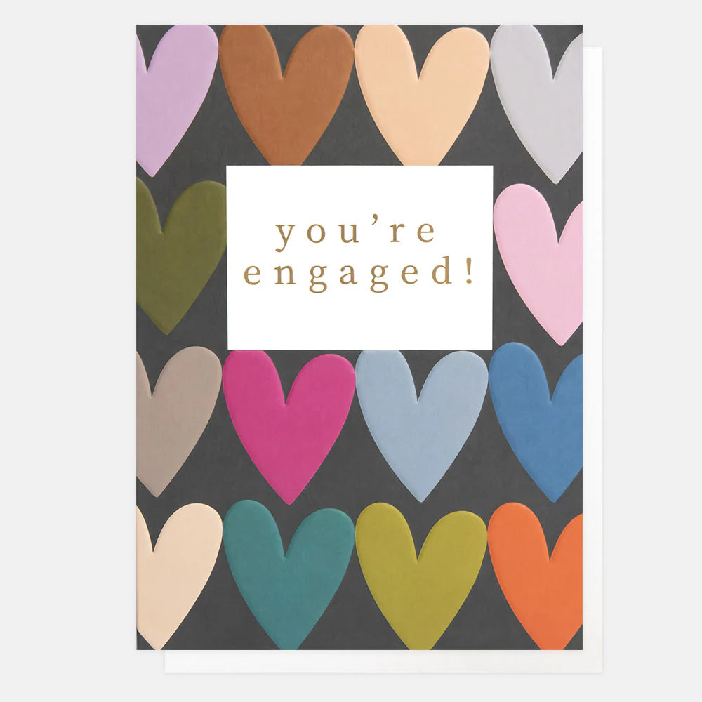 Caroline Gardner You're Engaged multi-heart rows card with colorful heart illustrations on a white background.
