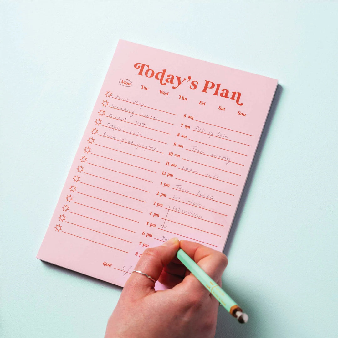 Pink and red A5 daily planner pad by Good Tuesday from Cornucopia Home and Gift, featuring detailed planning pages.