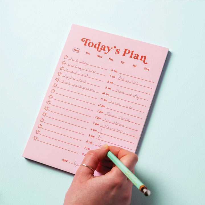 Pink and red A5 daily planner pad by Good Tuesday from Cornucopia Home and Gift, featuring detailed planning pages.
