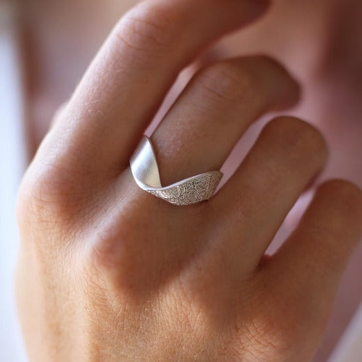 Silver Praise Ring by Tutti &amp; Co featuring intricate design, displayed on a neutral background with soft lighting.