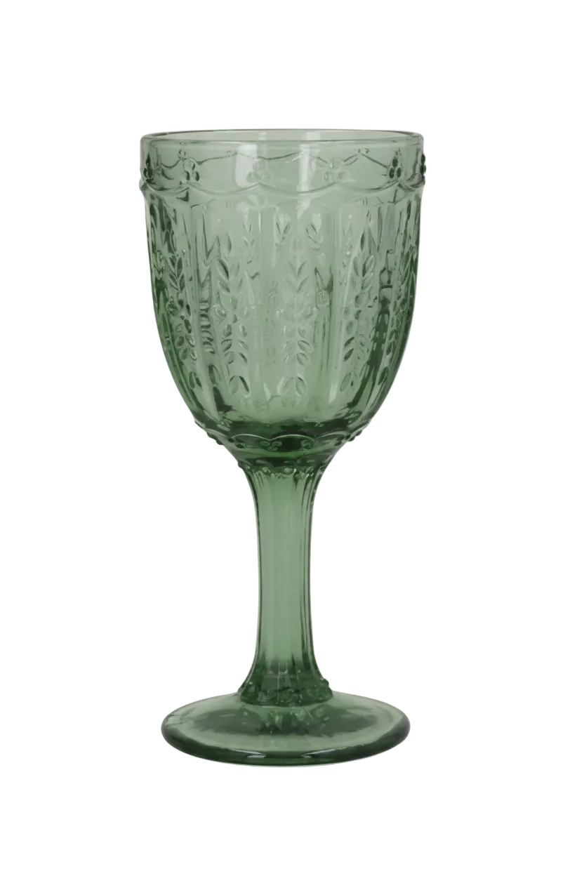 Green glass goblet with textured design on a white background