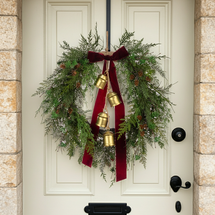 Decorative Christmas wreath with a bow and bells, featuring floralsilk accents from Cornucopia Home and Gift for the 2025 holiday season.